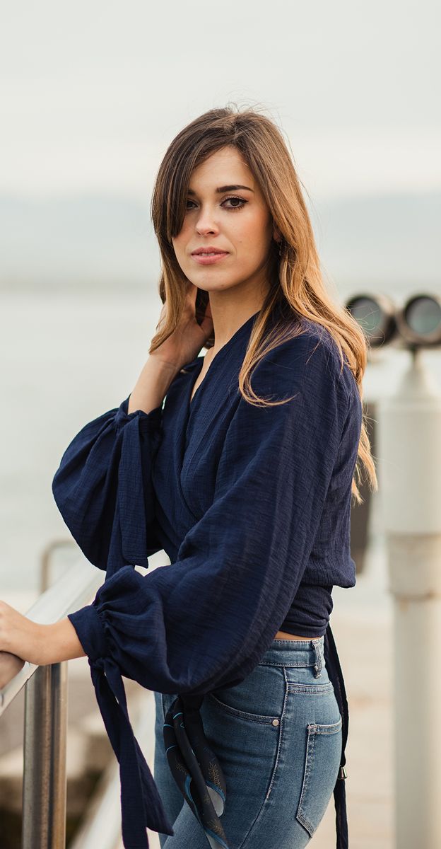 med spa patient model in navy top by water railing.