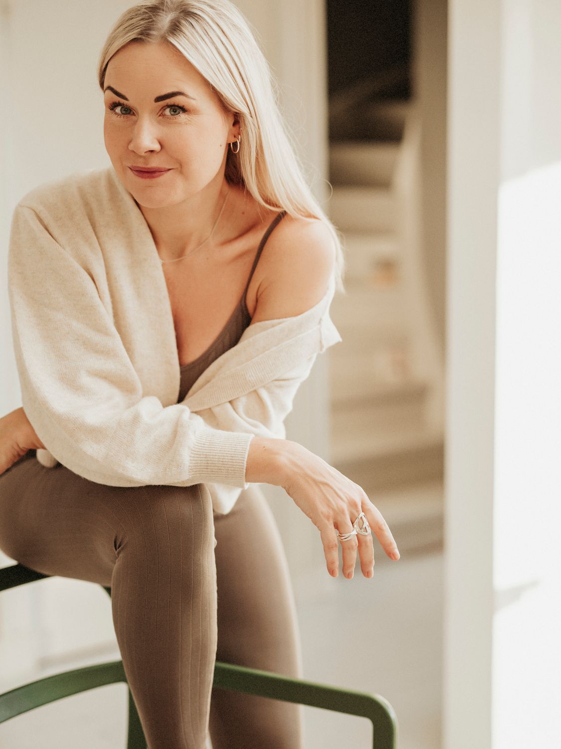 menopause treatment patient model in activewear with long, flowing blonde hair.