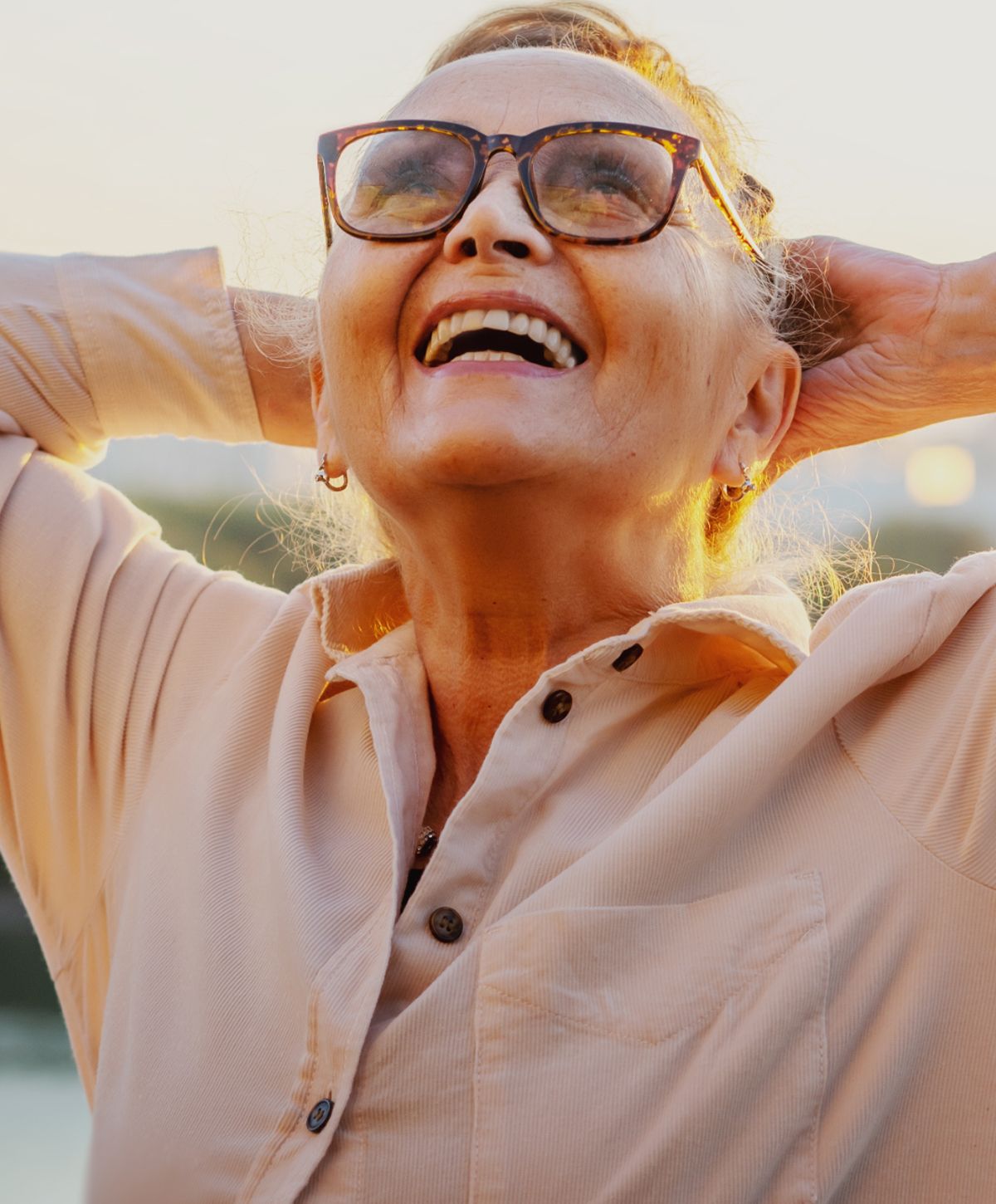 Joyful older longevity medicine patient model  enjoying sunset moment.