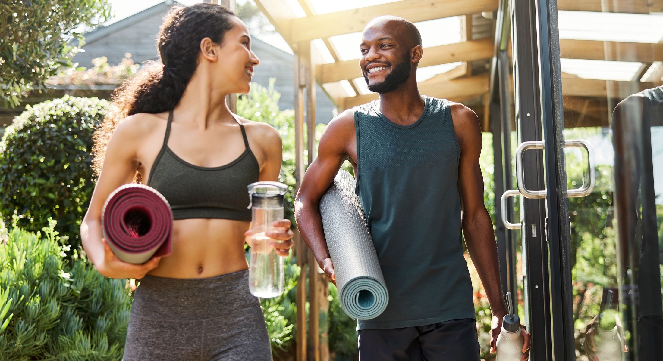 med spa patient models walking with yoga mats and water bottles.
