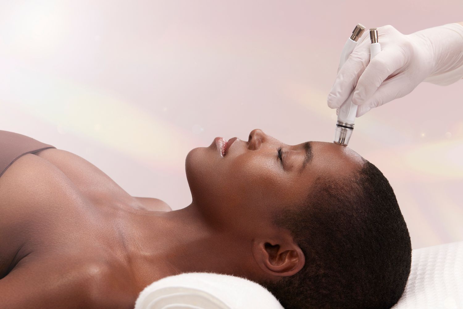 diamondglow facial patient model receiving a facial treatment with microneedling.